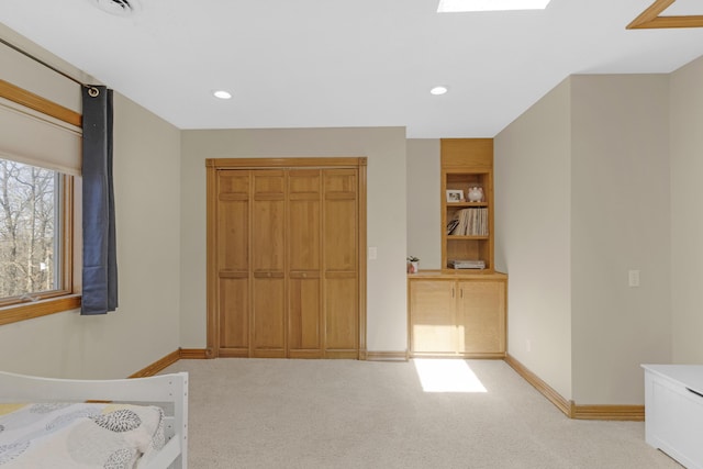 unfurnished bedroom with recessed lighting, baseboards, and light carpet