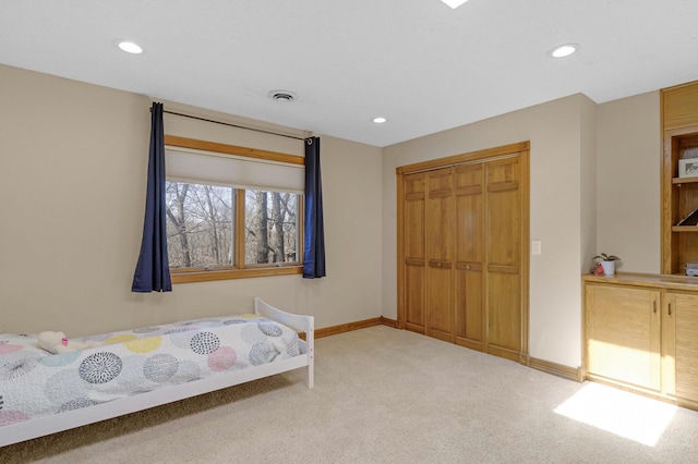 unfurnished bedroom featuring visible vents, baseboards, carpet, recessed lighting, and a closet