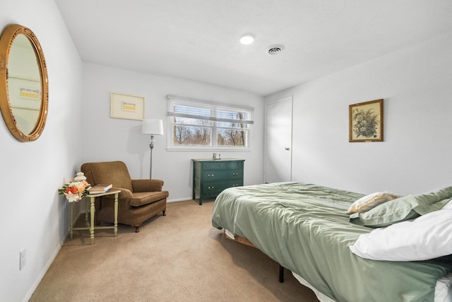 bedroom featuring visible vents, light colored carpet, and baseboards