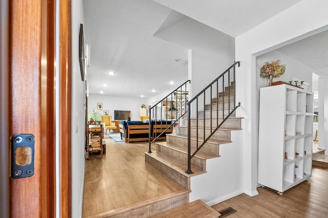 foyer entrance with wood finished floors, visible vents, baseboards, recessed lighting, and stairs