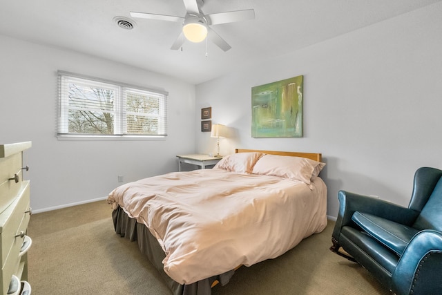 bedroom featuring visible vents, baseboards, light colored carpet, and ceiling fan