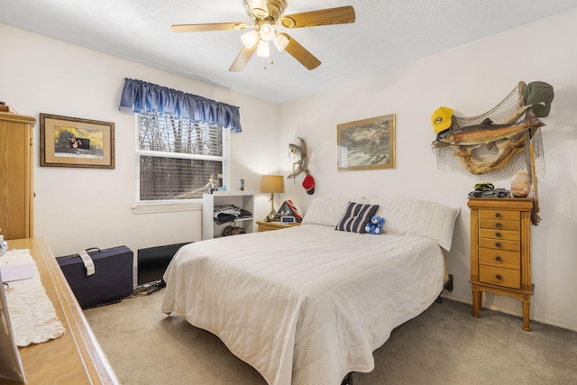 carpeted bedroom with baseboards and ceiling fan