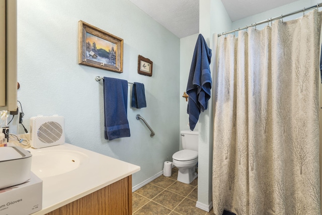 bathroom featuring tile patterned flooring, toilet, vanity, and baseboards