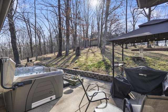 view of patio / terrace featuring a grill and a hot tub