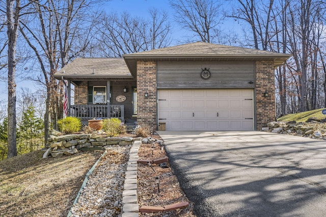 view of front facade with brick siding, aphalt driveway, a porch, roof with shingles, and an attached garage