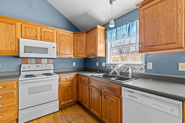 kitchen with light wood-style flooring, a sink, white appliances, vaulted ceiling, and hanging light fixtures