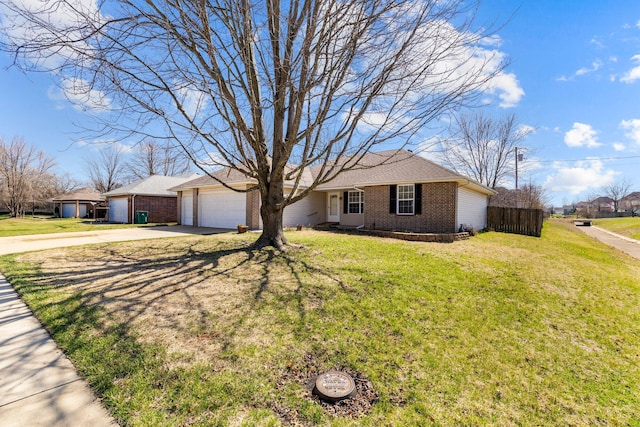 single story home featuring fence, concrete driveway, a front yard, a garage, and brick siding