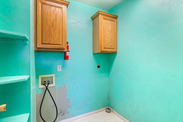 clothes washing area featuring baseboards, light floors, hookup for a washing machine, cabinet space, and hookup for an electric dryer