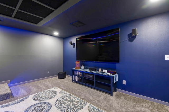 carpeted home theater room with visible vents and baseboards