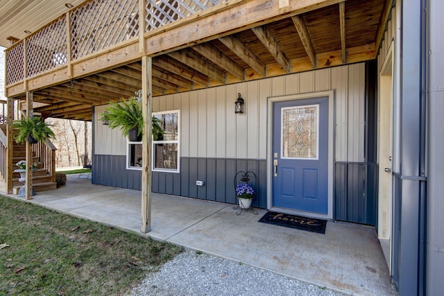 view of exterior entry with a patio