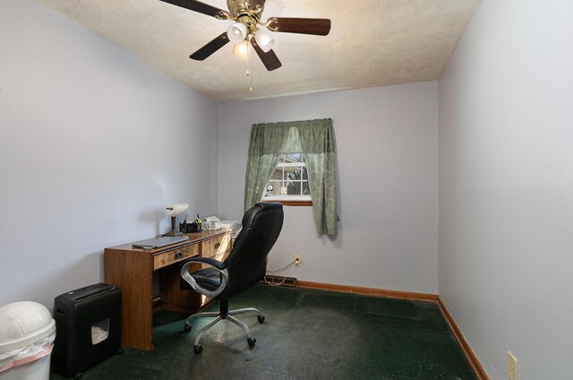 unfurnished office featuring carpet, baseboards, and ceiling fan