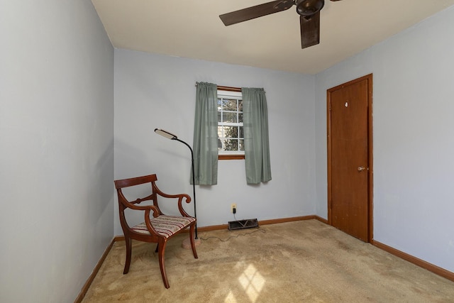 living area featuring ceiling fan, baseboards, and carpet