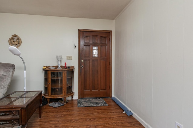 foyer with wood finished floors and baseboards