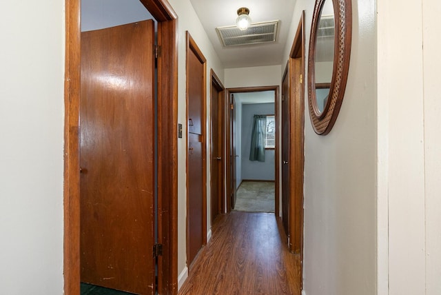 corridor with visible vents and wood finished floors