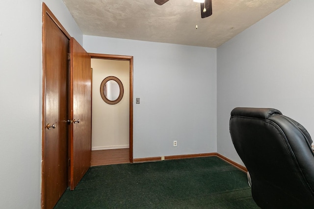 office area featuring a ceiling fan, baseboards, carpet floors, and a textured ceiling