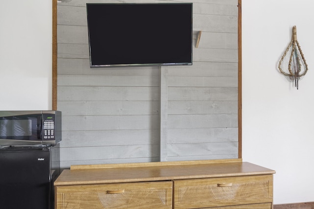 interior details with wooden walls and fridge