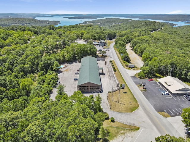 birds eye view of property featuring a wooded view and a water view