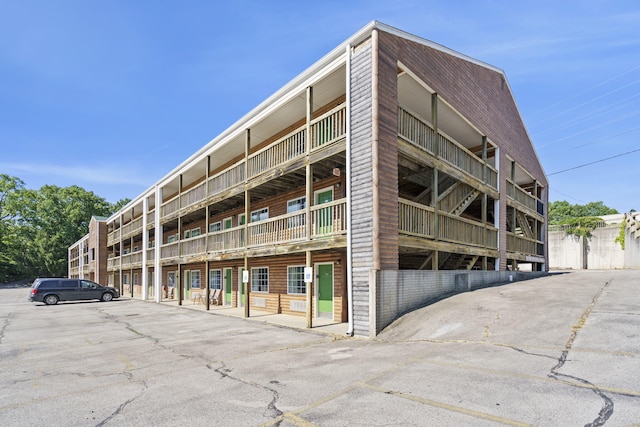 view of building exterior with uncovered parking