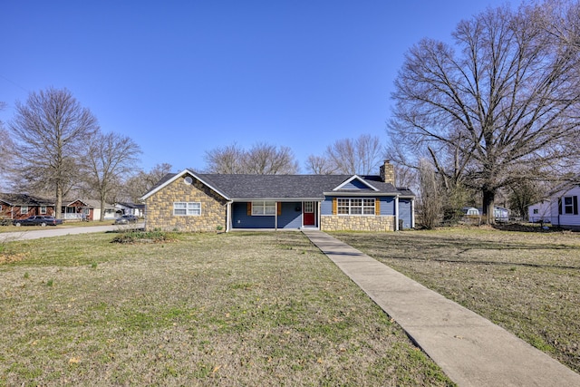 view of front facade featuring a front lawn, stone siding, roof with shingles, and a chimney