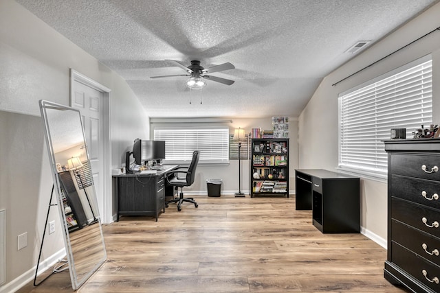 home office with wood finished floors, a ceiling fan, baseboards, and a textured ceiling