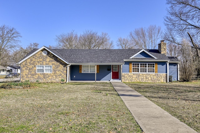 ranch-style house with stone siding, a chimney, a front yard, and a shingled roof