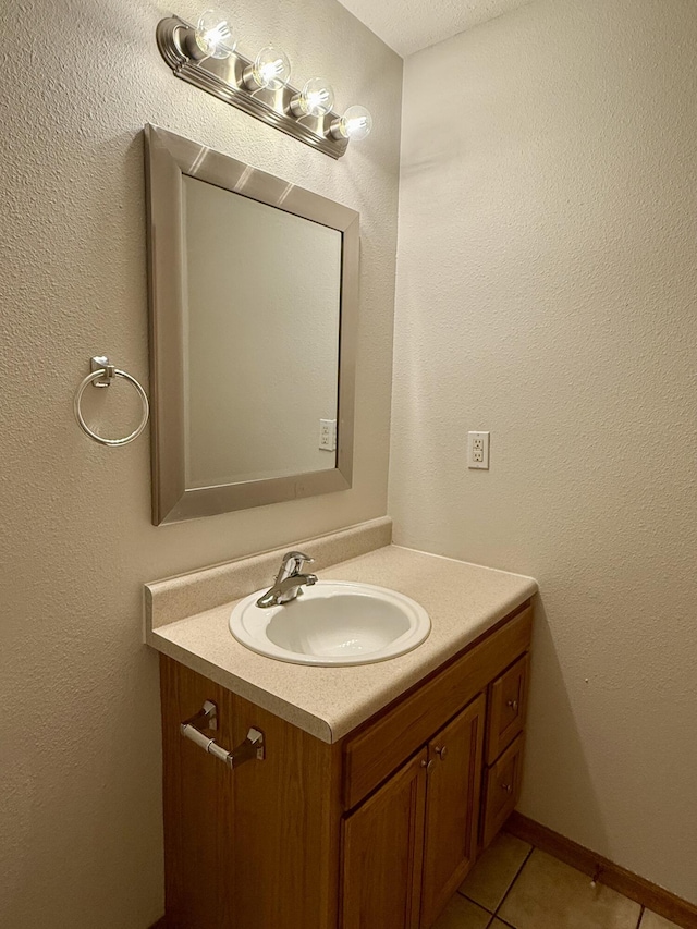 bathroom with tile patterned flooring and vanity