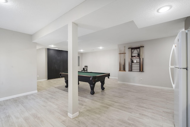 game room with pool table, a textured ceiling, light wood-type flooring, and baseboards