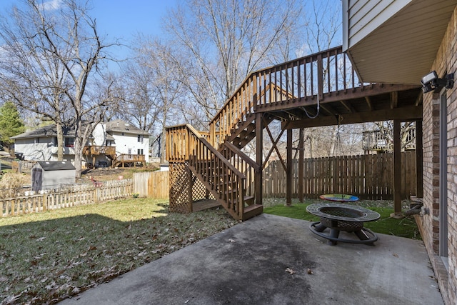 view of patio / terrace featuring stairs, a deck, and a fenced backyard