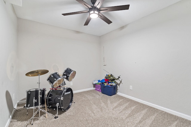 playroom featuring baseboards, a ceiling fan, and carpet flooring