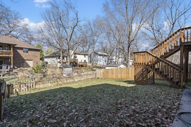 view of yard featuring a fenced backyard and stairs