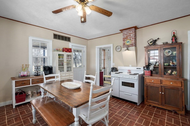 dining area featuring visible vents, brick patterned floor, a ceiling fan, and ornamental molding