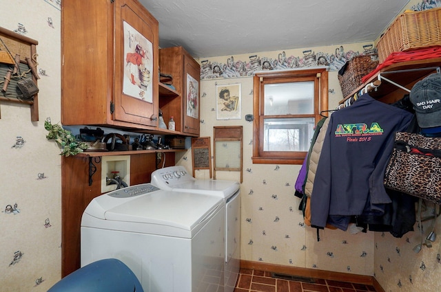 washroom with wallpapered walls, baseboards, cabinet space, and washing machine and clothes dryer