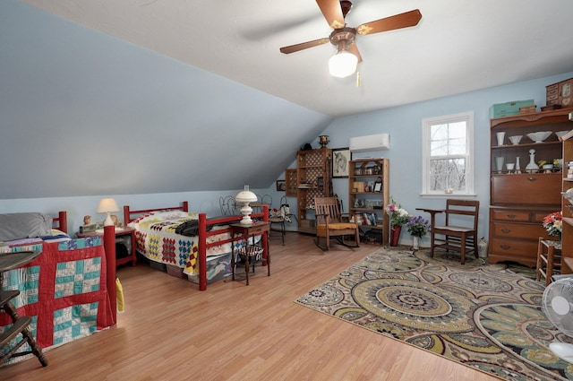 bedroom with vaulted ceiling and wood finished floors