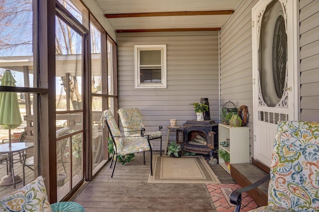 unfurnished sunroom with beamed ceiling