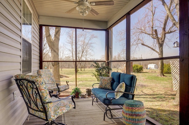 sunroom featuring a healthy amount of sunlight and ceiling fan