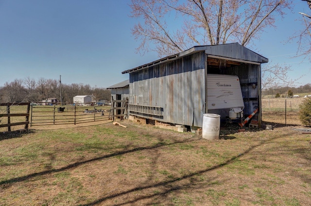 view of pole building with a yard and fence