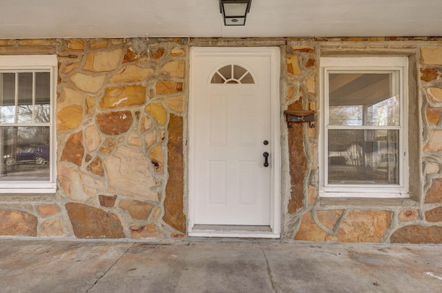 doorway to property featuring stone siding