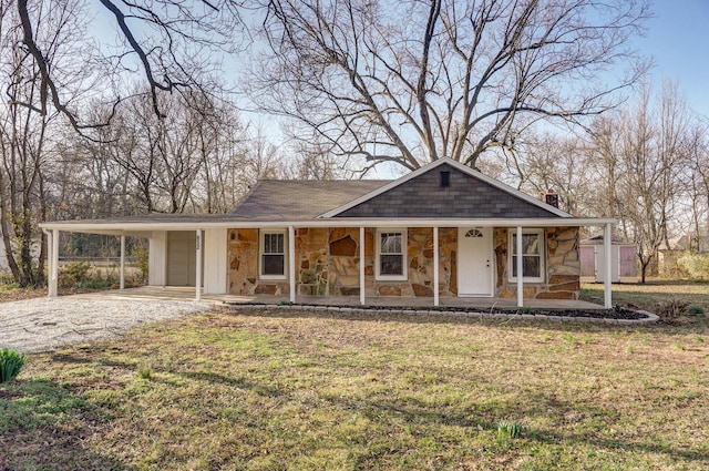 view of front facade featuring stone siding, an attached carport, a porch, and driveway