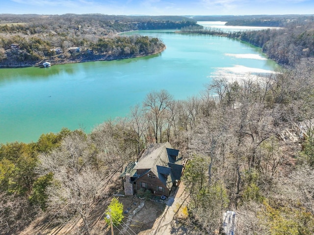 aerial view featuring a view of trees and a water view