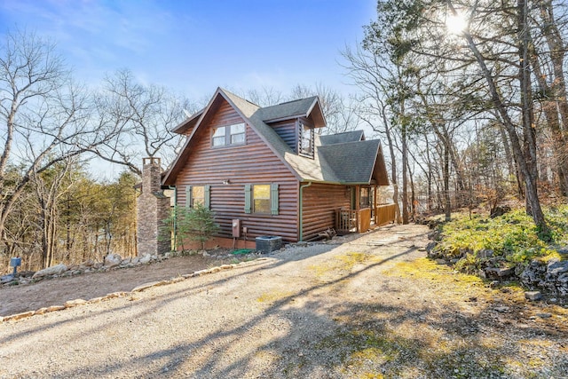 view of home's exterior featuring a porch and roof with shingles