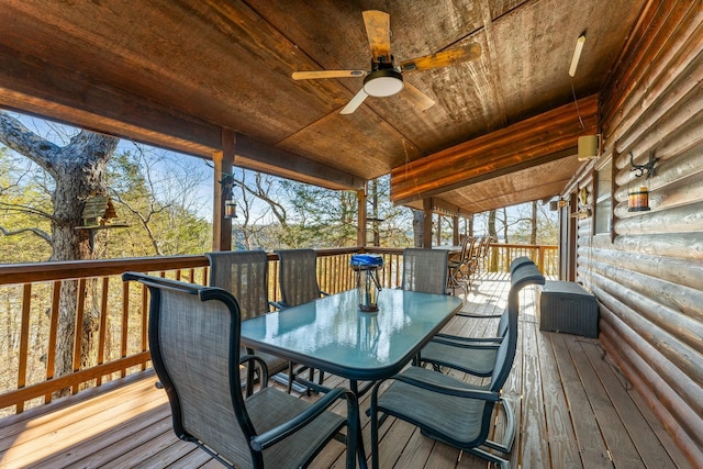 wooden terrace featuring outdoor dining area and ceiling fan