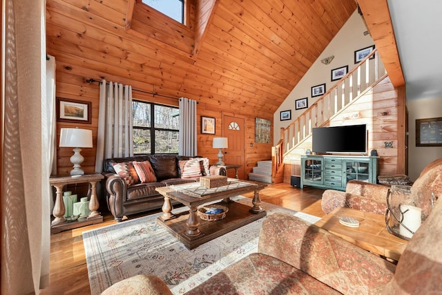 living area with wood ceiling, wood finished floors, stairs, and wood walls