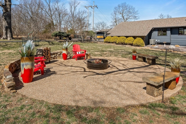 exterior space with central AC unit and an outdoor fire pit