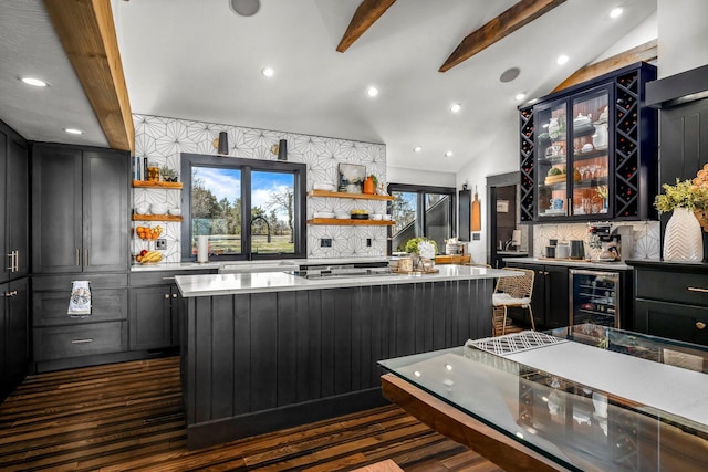 bar with decorative backsplash, lofted ceiling with beams, dark wood-style floors, and a sink