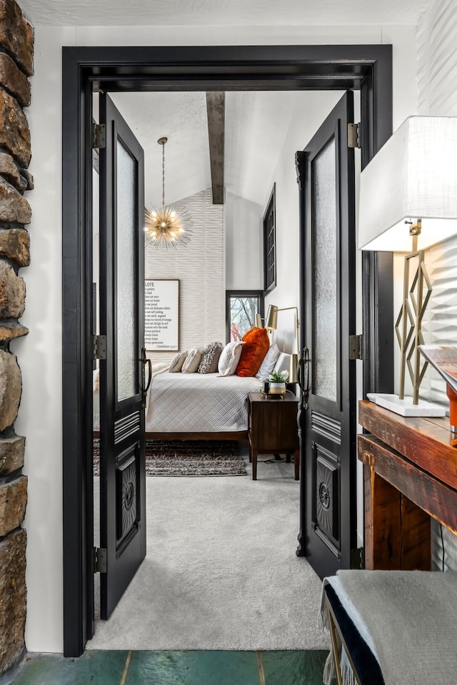 bedroom featuring an inviting chandelier, lofted ceiling with beams, and carpet