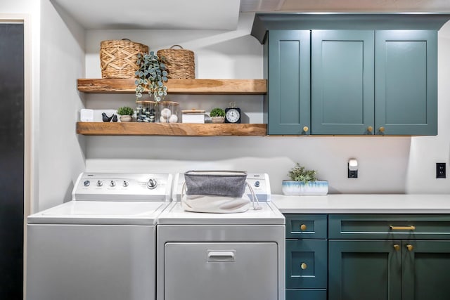 laundry room with washing machine and dryer and cabinet space