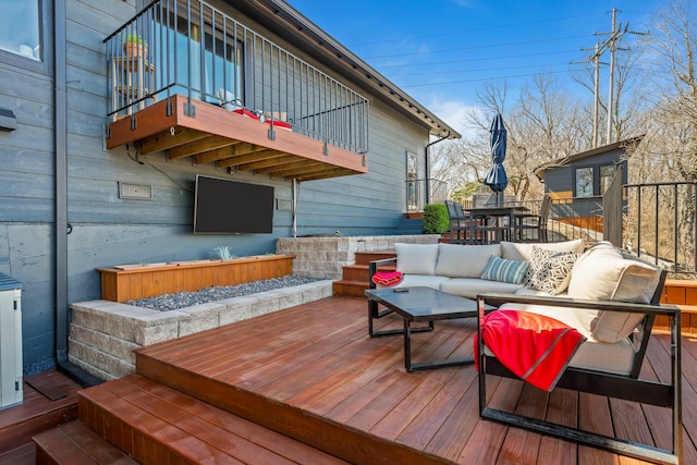 wooden deck with an outdoor living space and outdoor dining area