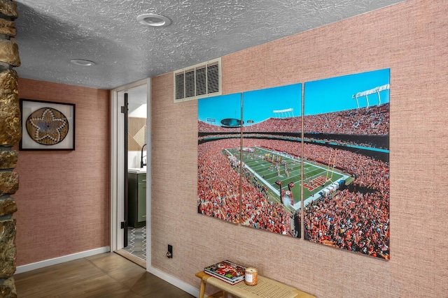 interior space with baseboards and a textured ceiling