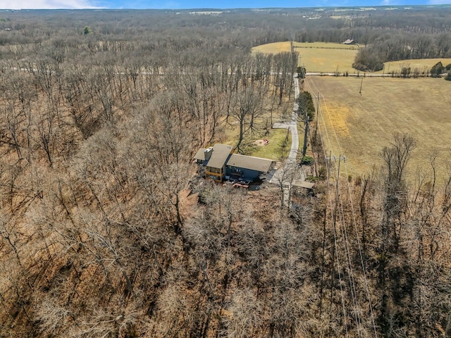 birds eye view of property featuring a rural view and a wooded view