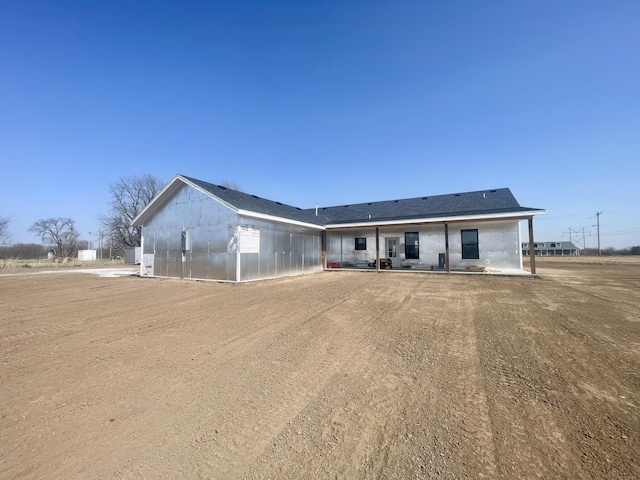 rear view of house featuring an exterior structure and an outbuilding